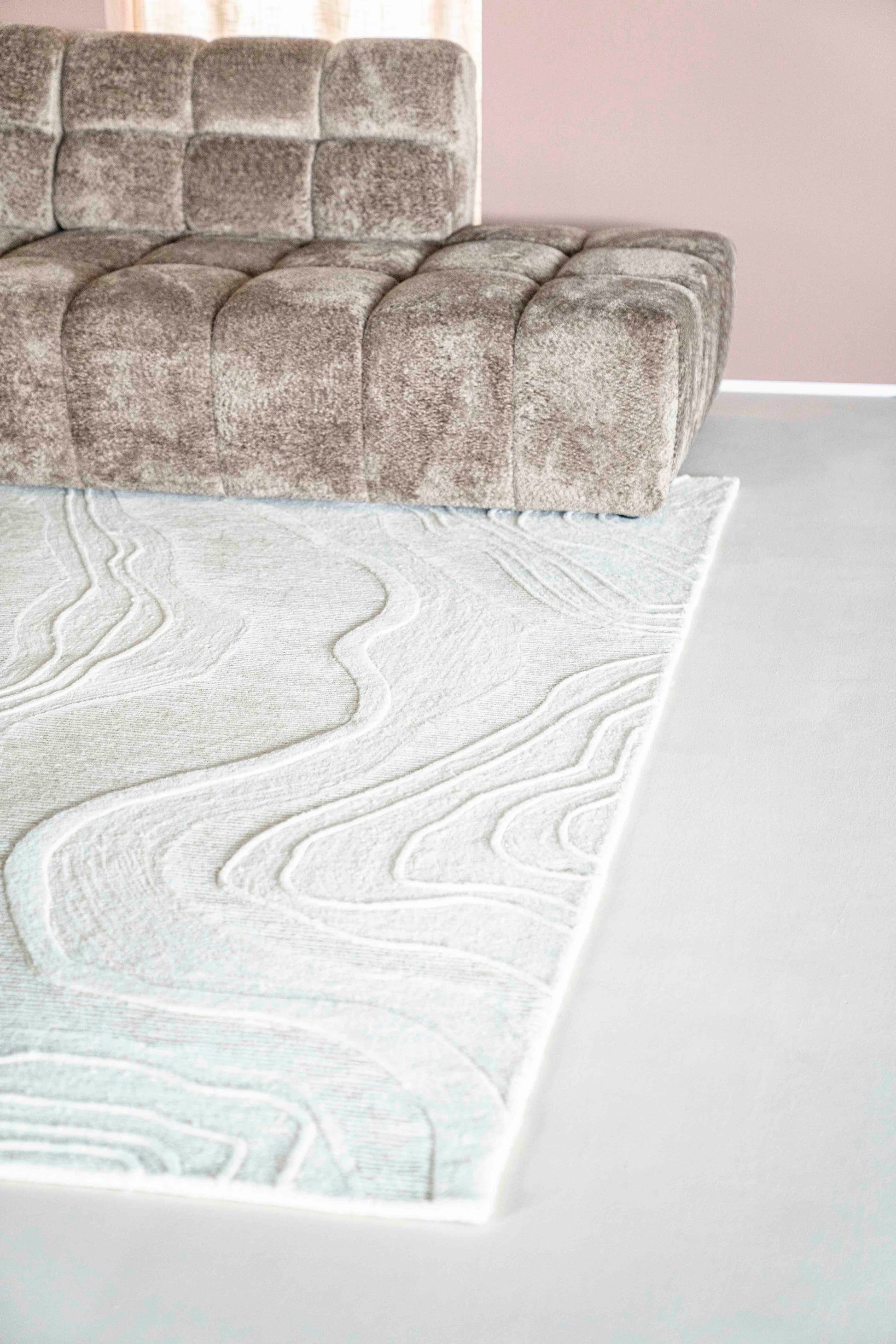 Miljøbilde med sofa, bord og kremhvit gulvteppe i ull